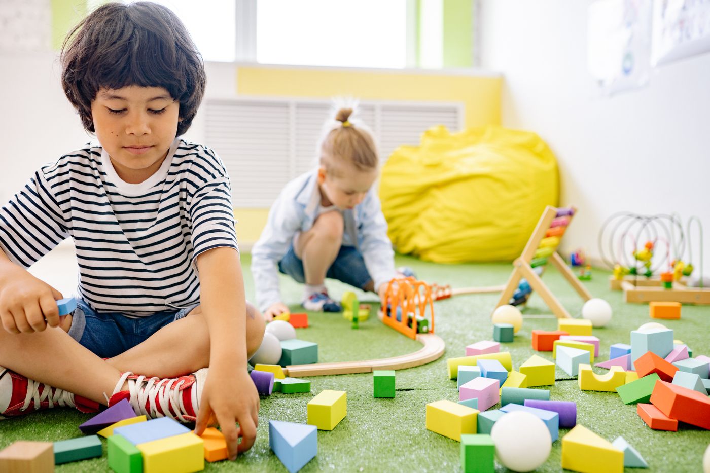 Children exploring colorful wooden blocks during play