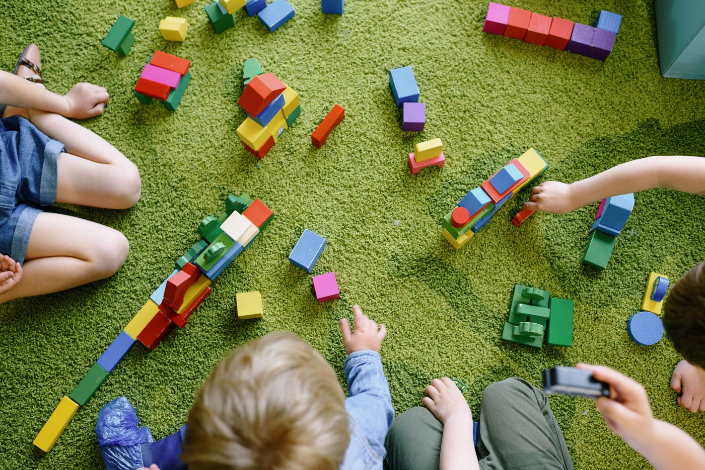 Children building colorful wooden structures together